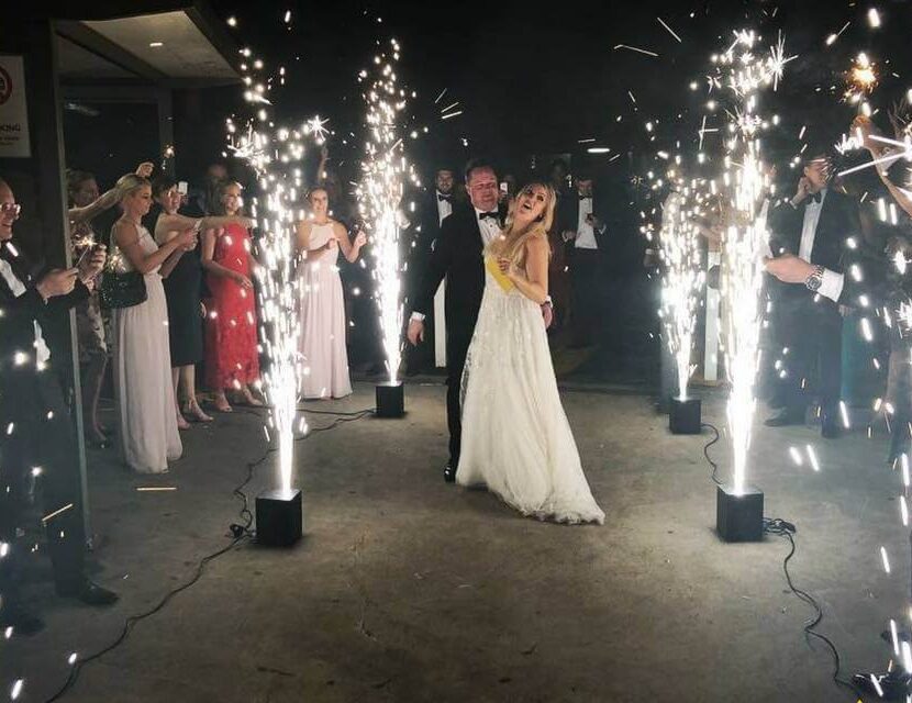 A couple is dancing in front of some sparklers.